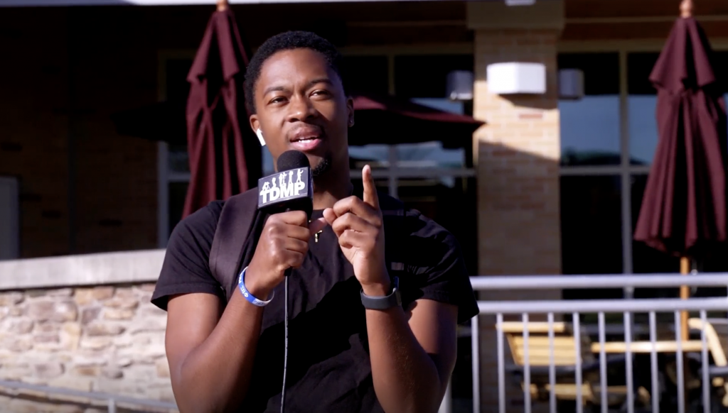 Man Holding Microphone and Answering a Question